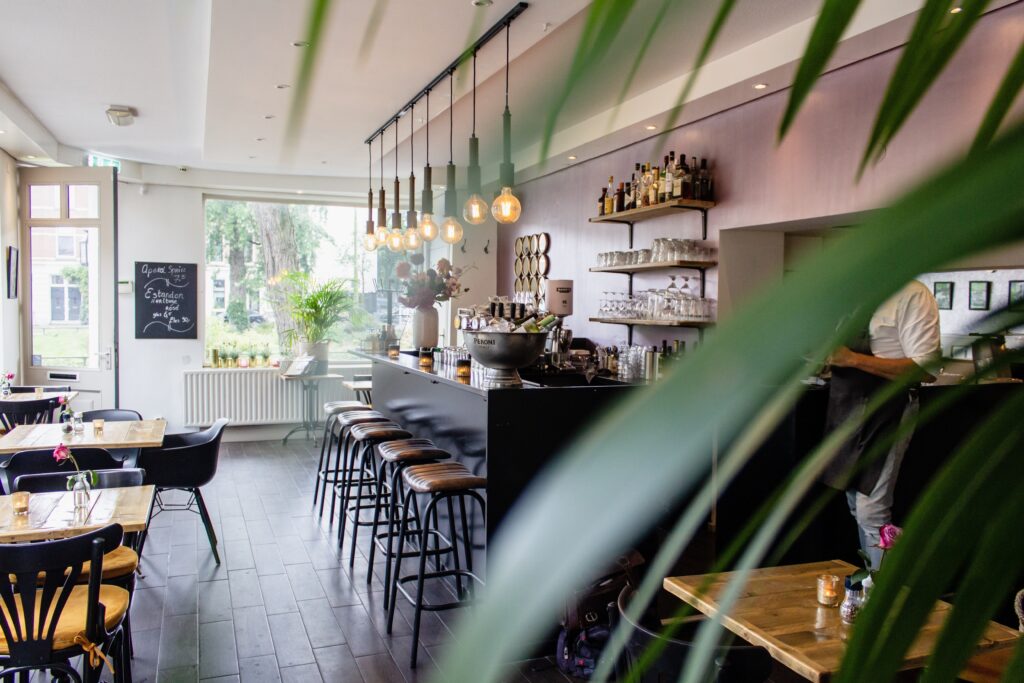 Café interior with seating near the bar and wooden tables