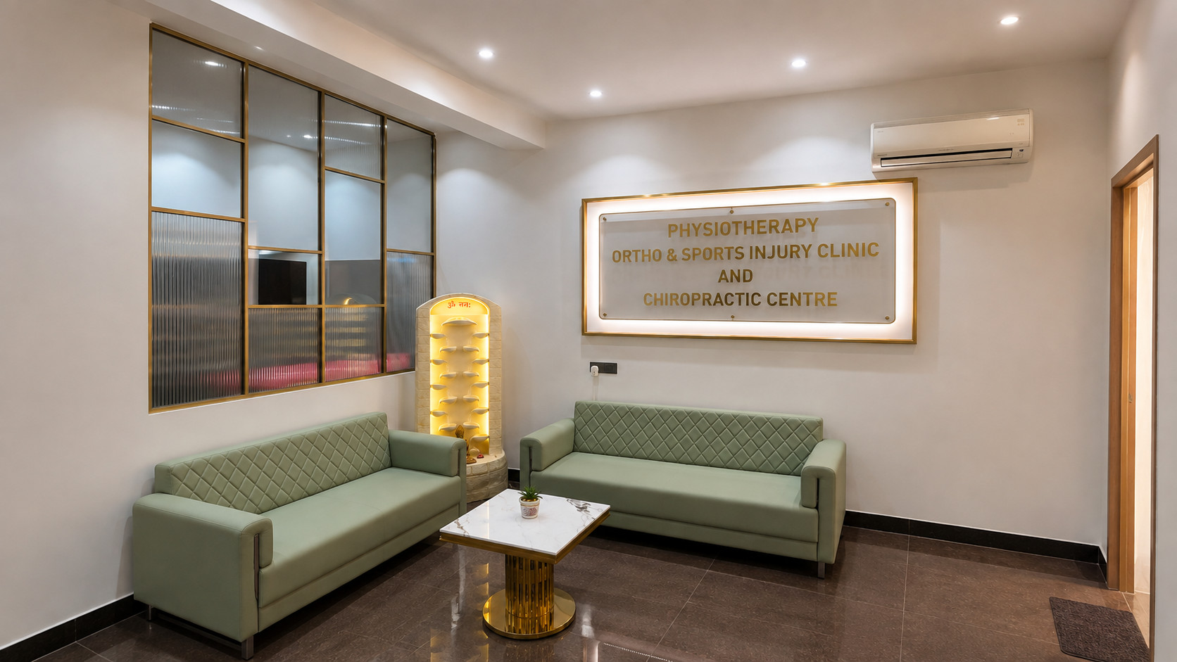 Physiotherapy Ortho & Sports Injury Clinic and Chiropractic Centre Waiting Lounge – Nail & Hammer Waiting lounge with mint-green sofas and a backlit brass-framed signage reading Physiotherapy Ortho & Sports Injury Clinic and Chiropractic Centre, interior designed by Nail & Hammer